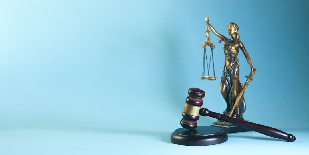 Contact law theme, mallet of the judge and scales of justice on a blue background